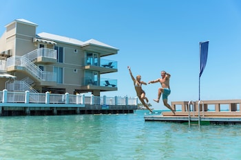 Private beach, white sand, sun loungers, beach umbrellas at Pier House Resort & Spa