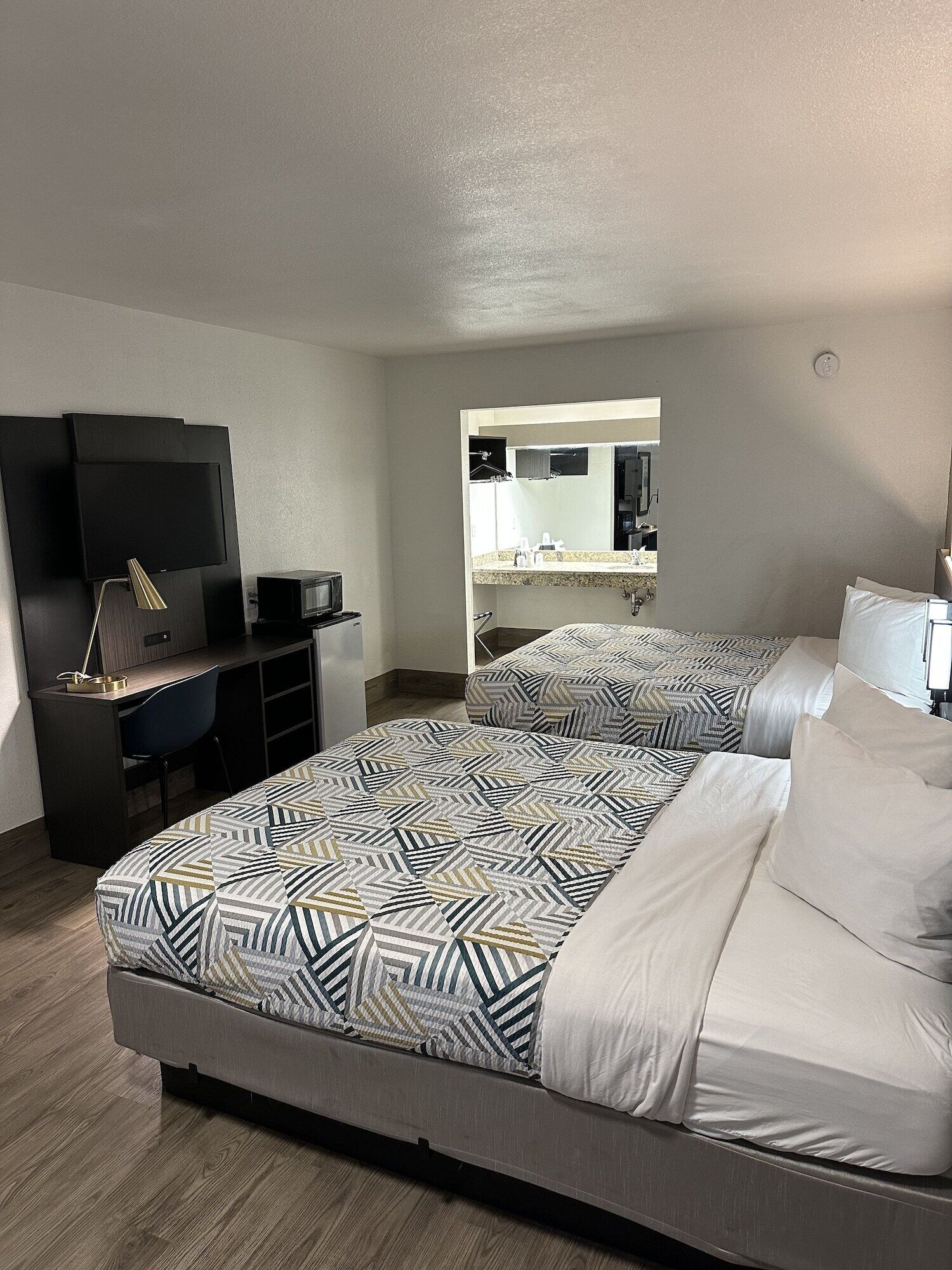 Desk, laptop workspace, iron/ironing board, free cribs/infant beds