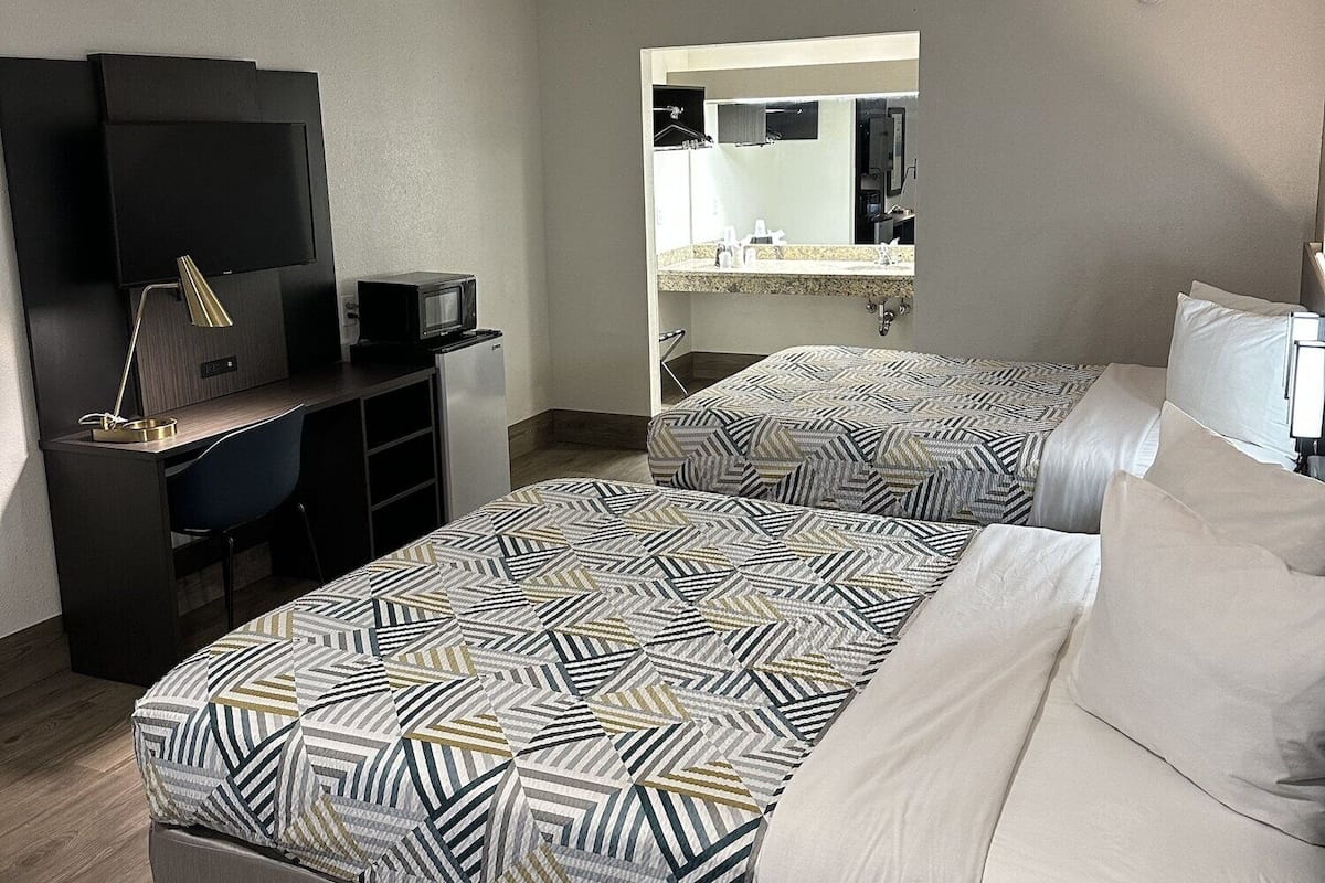 Desk, laptop workspace, iron/ironing board, free cribs/infant beds