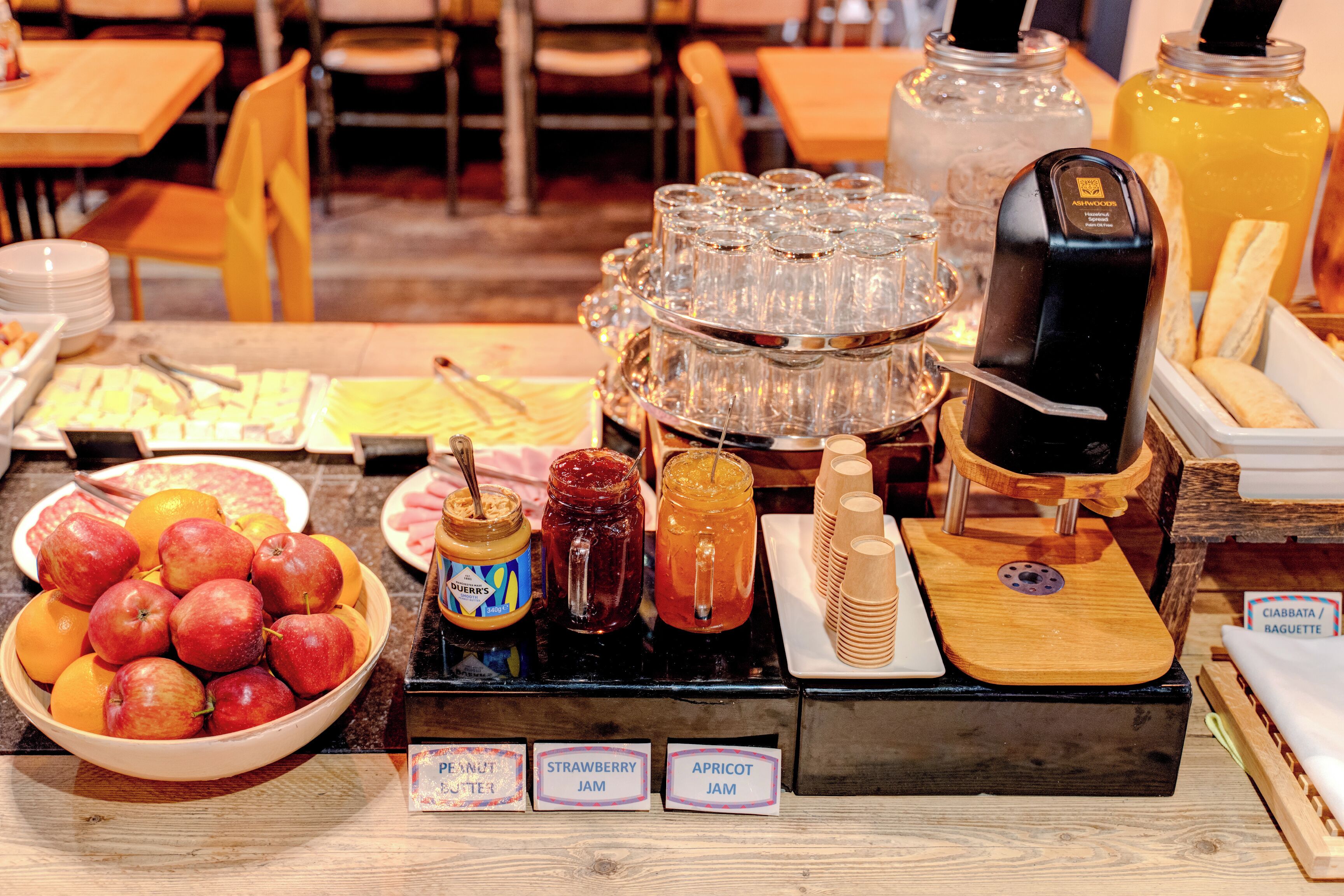 A buffet setup with various food items and beverages.