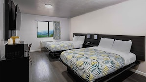 A hotel room with two beds, a large window with a city view, a desk with a computer, and a flat-screen TV. - Golden Inn Dallas East near I-30 Jim Miller (Dallas)