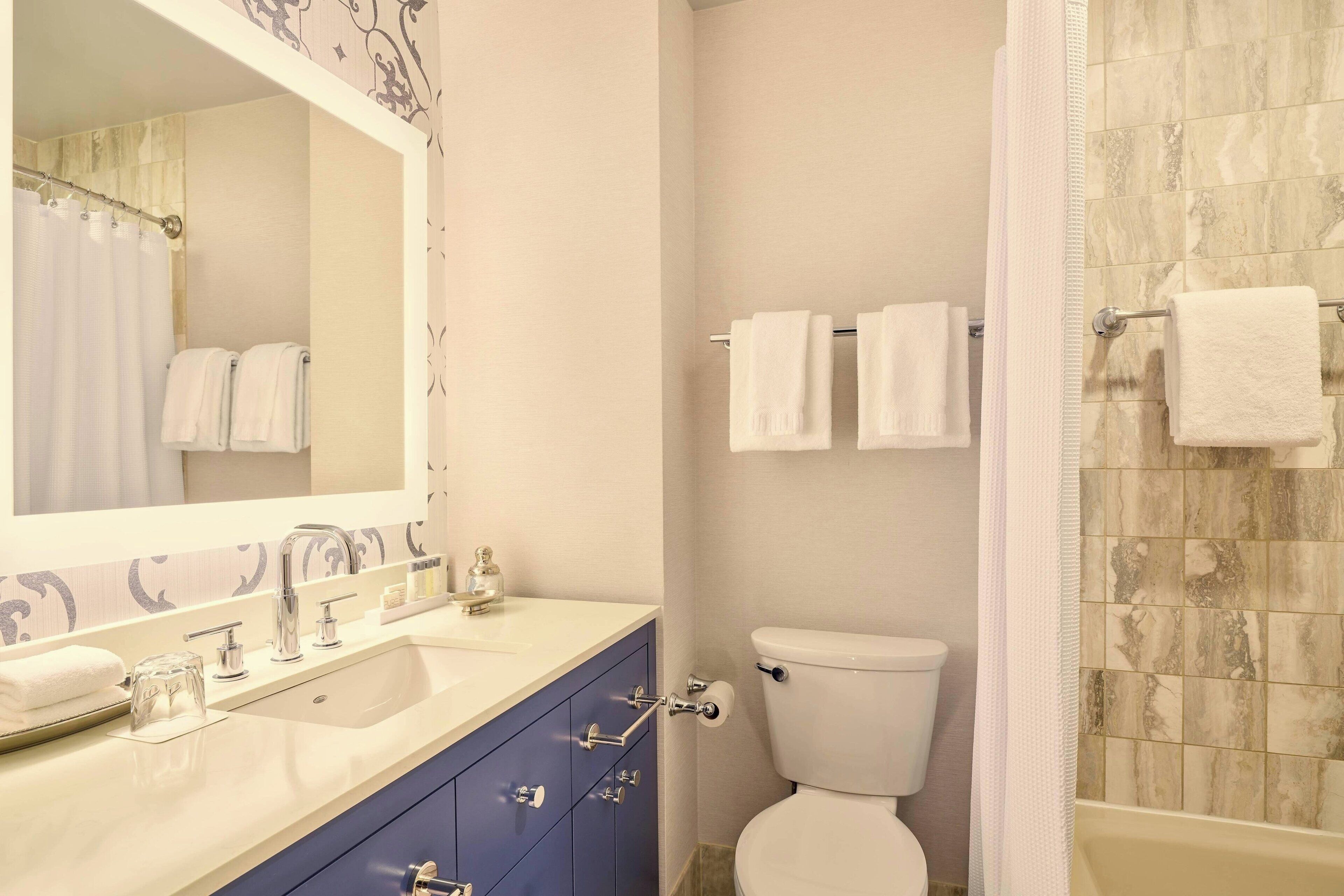 bathtub, designer toiletries, hair dryer, bathrobes