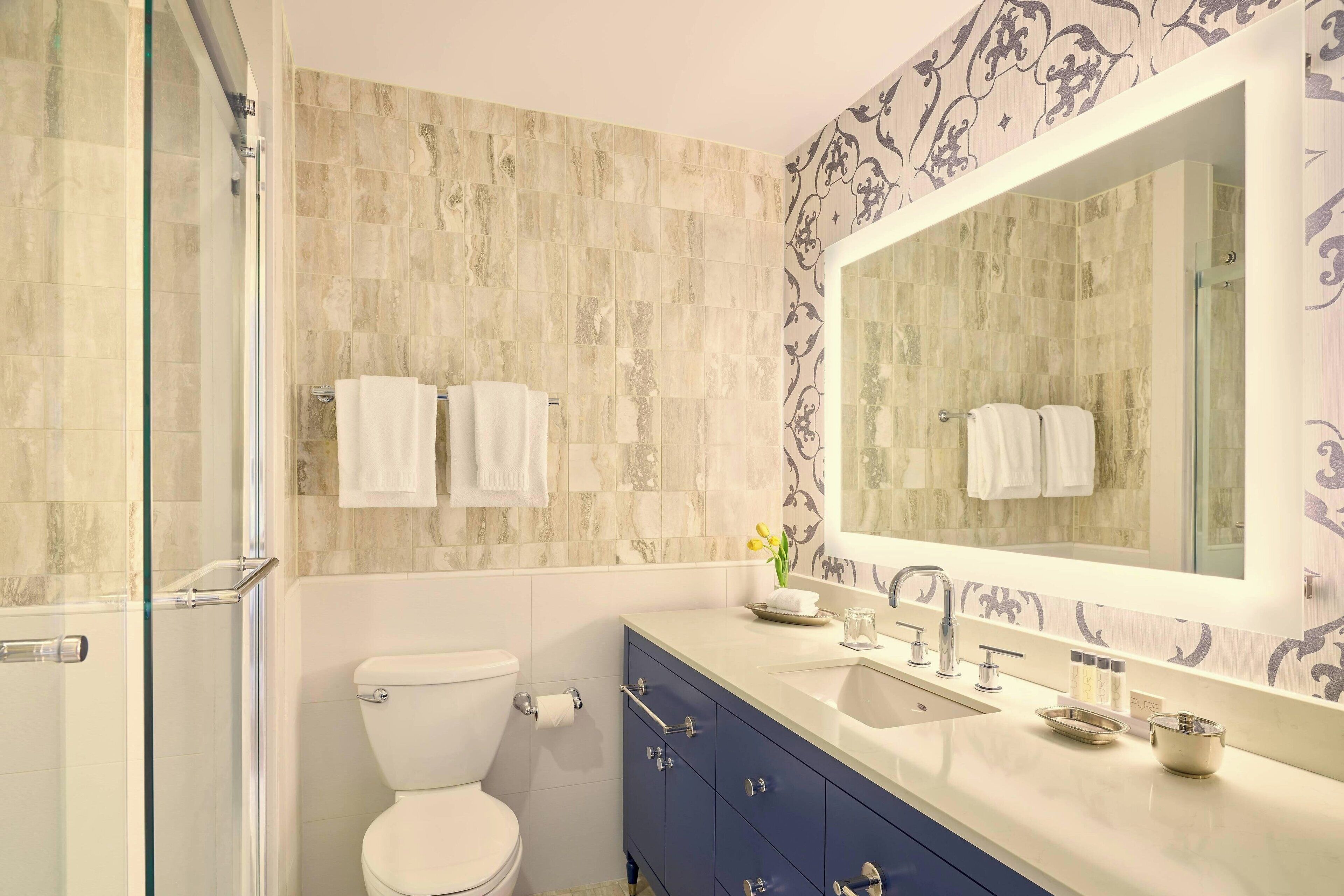 bathtub, designer toiletries, hair dryer, bathrobes