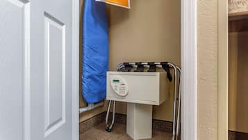 A white door, a blue curtain, a white cabinet with a control panel, and a metal crutch stand.