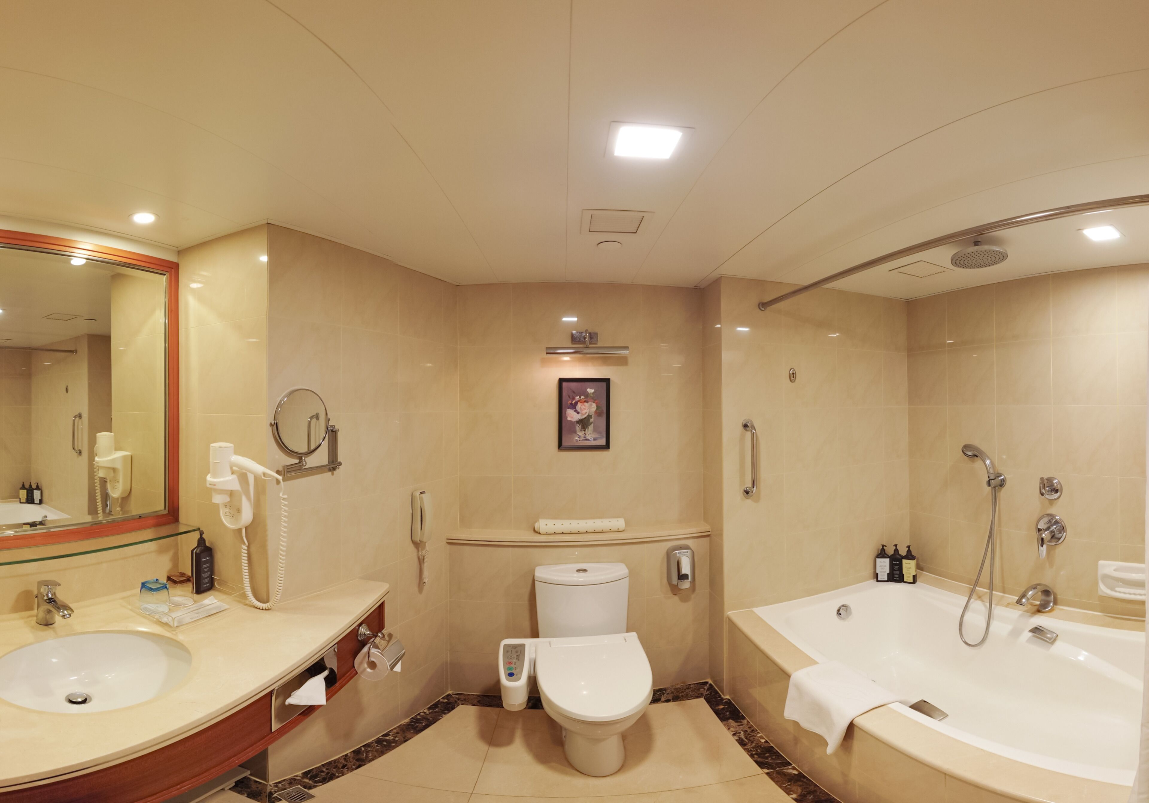 A modern bathroom with a sink, toilet, and bathtub.
