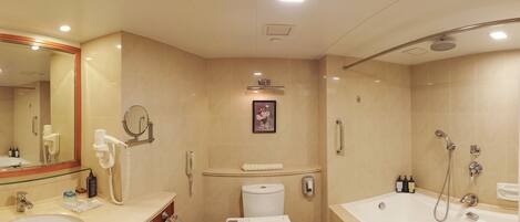 A modern bathroom with a sink, toilet, and bathtub.