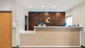 A reception desk with a wooden panel wall, a crescent moon design, and a 'WELCOME' sign. - Comfort Inn & Suites Wisconsin Dells (Wisconsin Dells)