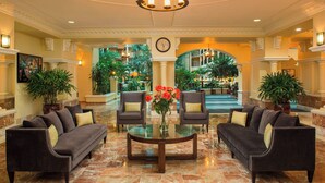A lobby with a marble floor, two sofas, a coffee table, and a chandelier. - Four Points by Sheraton Suites Tampa Airport Westshore (Tampa)