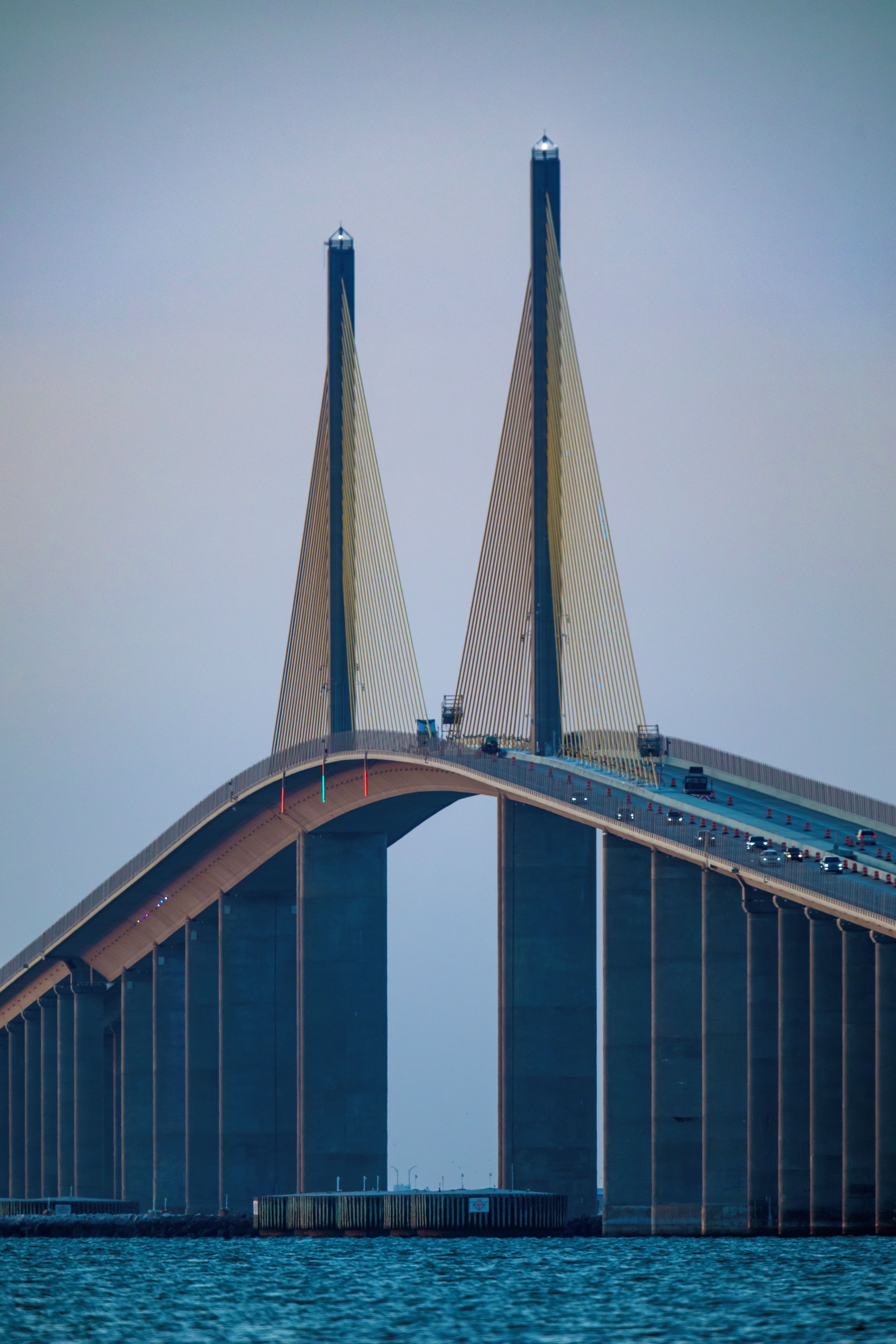 A large suspension bridge with two tall towers and a curved roadway.
