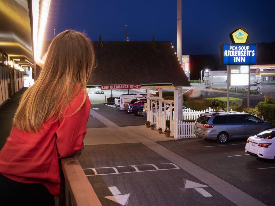 A parking lot with a sign for Andersen's and a sign for Pea Soup Andersen's Inn.