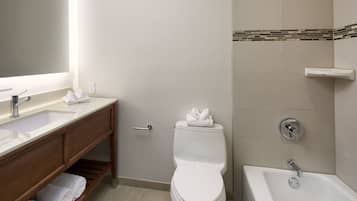 A bathroom with a toilet, sink, and bathtub.