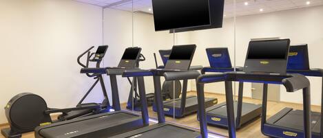 A fitness center with treadmills, elliptical machines, and a stationary bike.