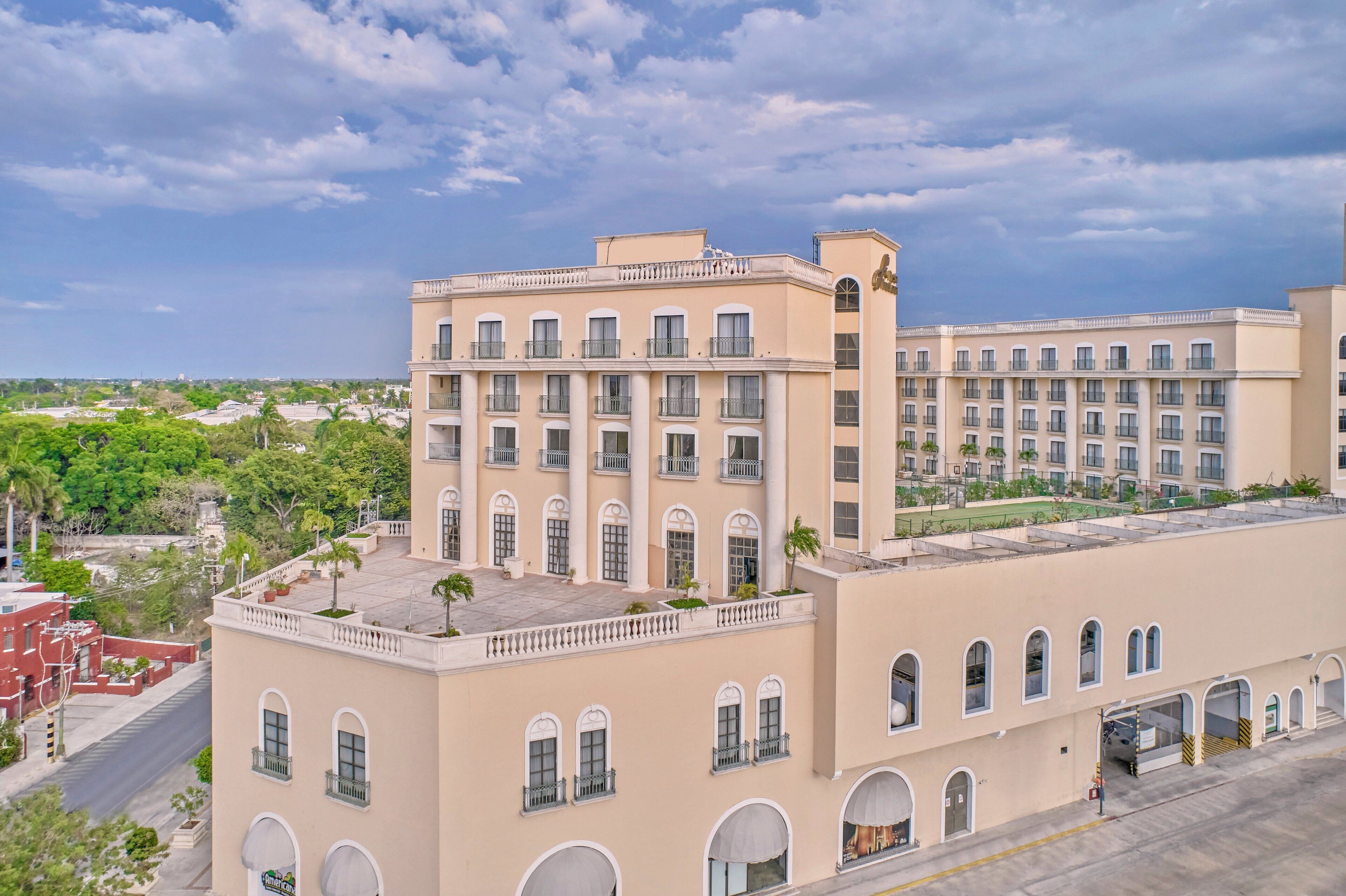 A multi-story hotel with a symmetrical facade, large windows, and balconies.