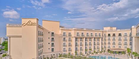 A hotel with a large pool, multiple balconies, and a sign reading "Fiesta Americana."