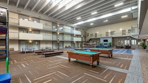A spacious indoor recreational area with multiple pool tables, a ping pong table, and a seating area with couches and chairs. - Best Western Plus Leamington Hotel & Conference Centre (Leamington)