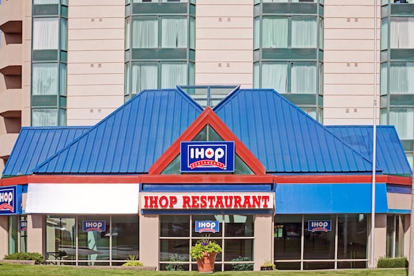 A two-story IHOP restaurant with a blue roof and a red and white facade.