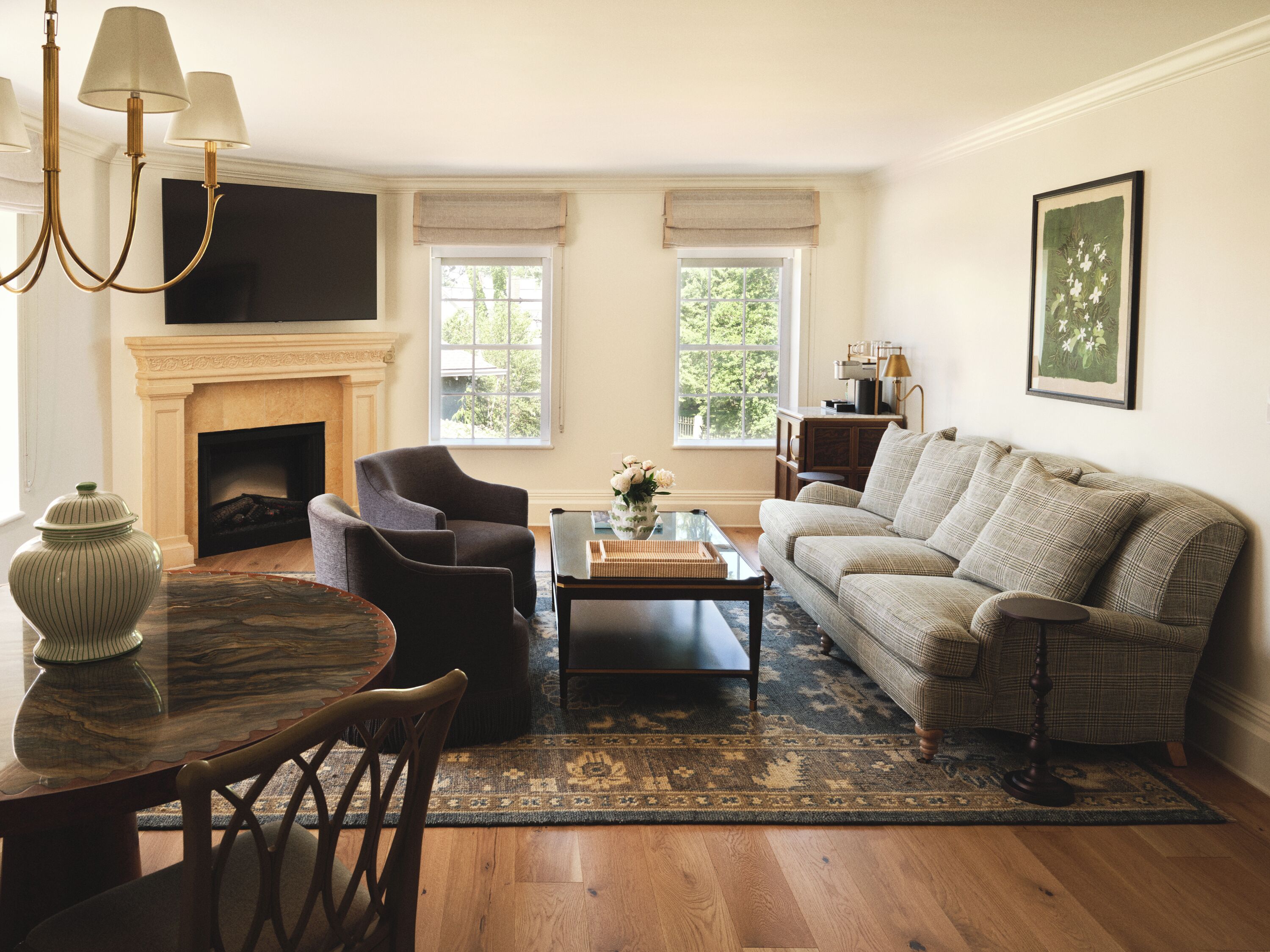 A living room with a fireplace, a sofa, a coffee table, and a television.
