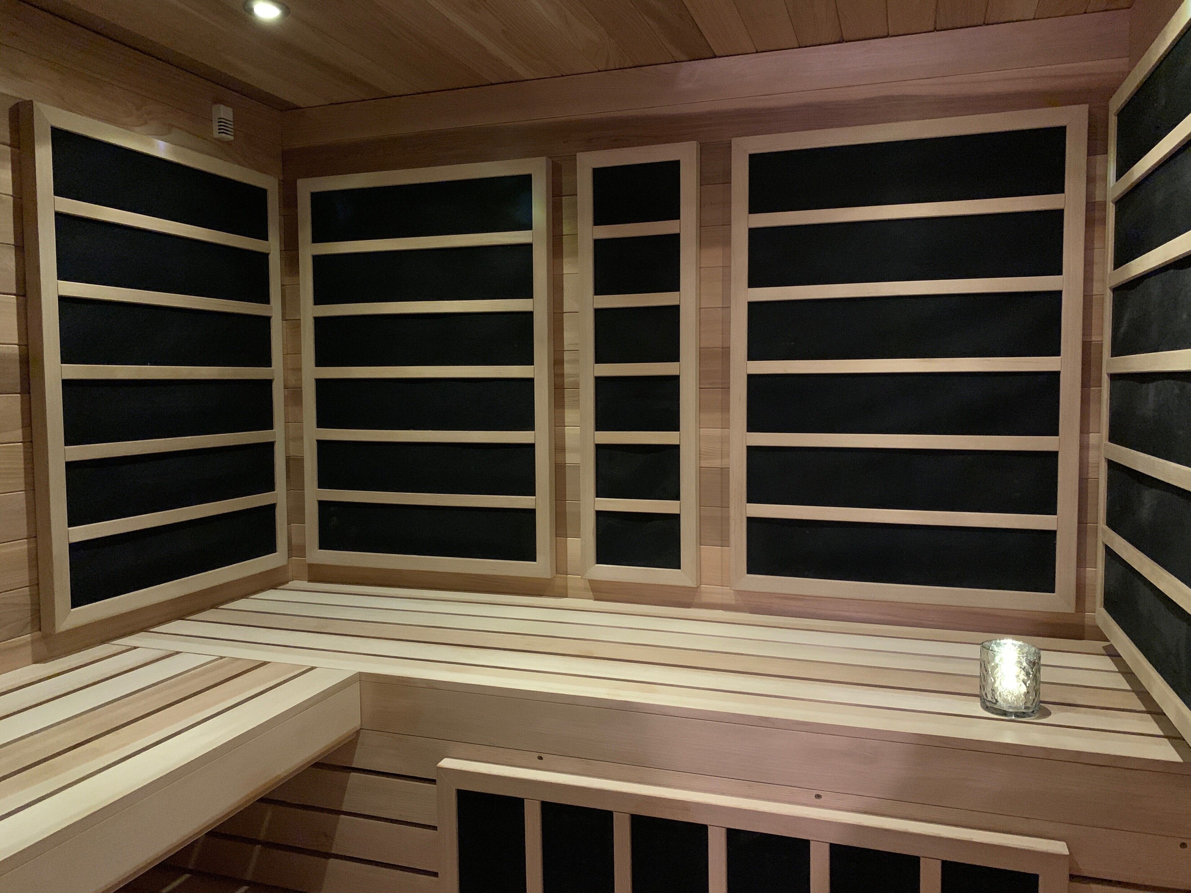 A sauna with wooden benches and glass panels.