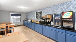 A kitchen with blue cabinets, a coffee machine, and a Florida's Natural sign.