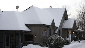 A building with a snow-covered roof and a sign that reads "Cliff Dweller." - The Cliff Dweller on Lake Superior (Tofte)