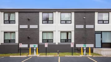 A modern building with a parking lot in front.