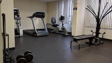 A gym with treadmills, stationary bikes, and weight equipment.