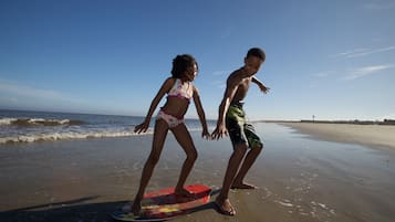 Guests can enjoy surfing and relaxing on this wide, open beach.