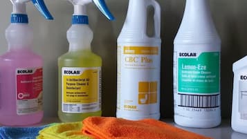 A variety of cleaning products and towels.