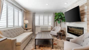 Suite, 1 King Bed, Non Smoking, Fireplace (with Sofabed) | Living area | 55-inch flat-screen TV with satellite channels, TV