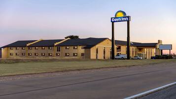 A Days Inn hotel with a large sign, multiple windows, and a parking lot.