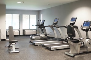 A gym with treadmills, a stationary bike, and a bench. - Holiday Inn Express Hickory-Hickory Mart by IHG (Hickory)