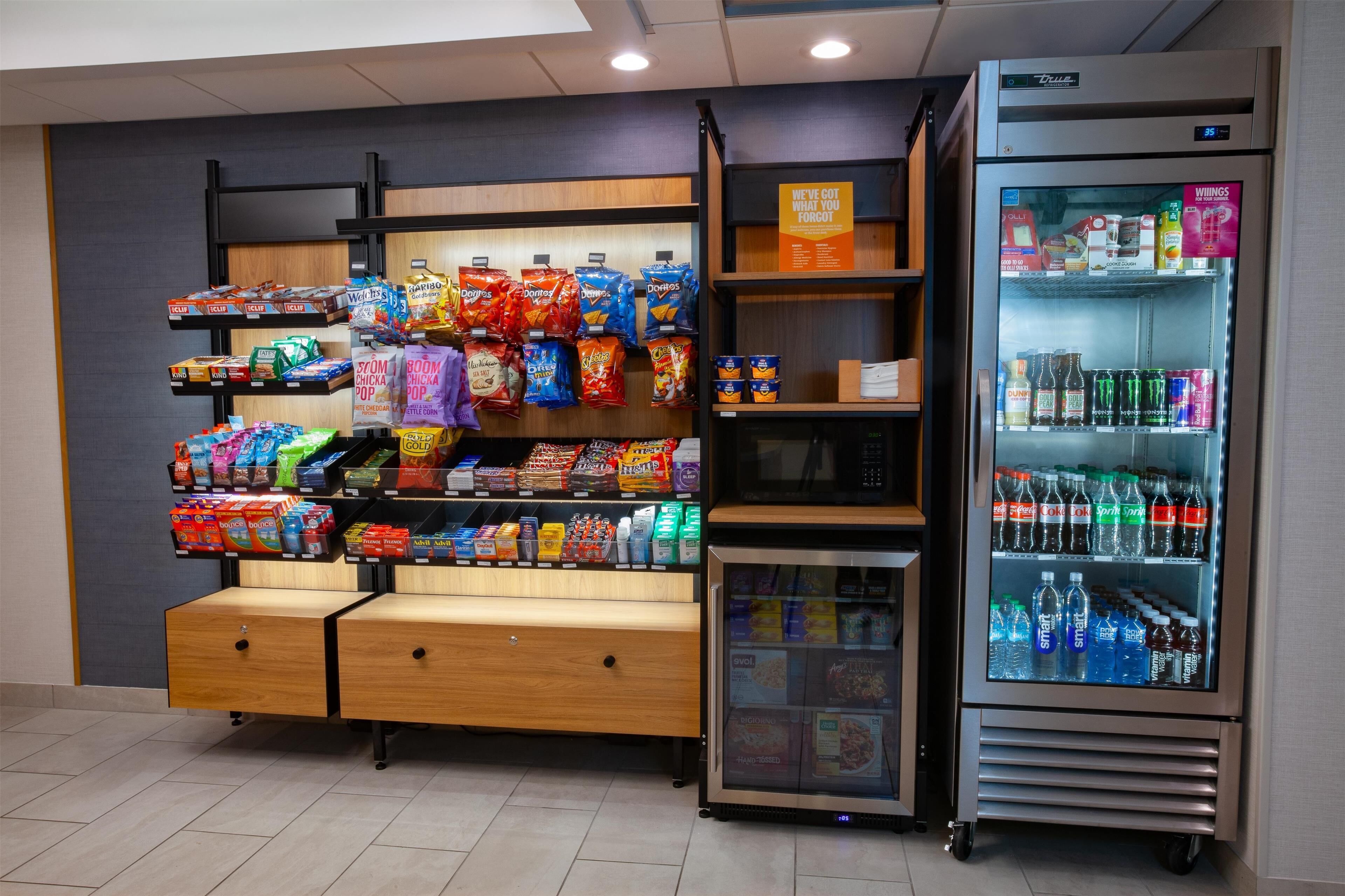 Máquina expendedora de aperitivos con papas fritas y una fuente refrigerada para bebidas.
