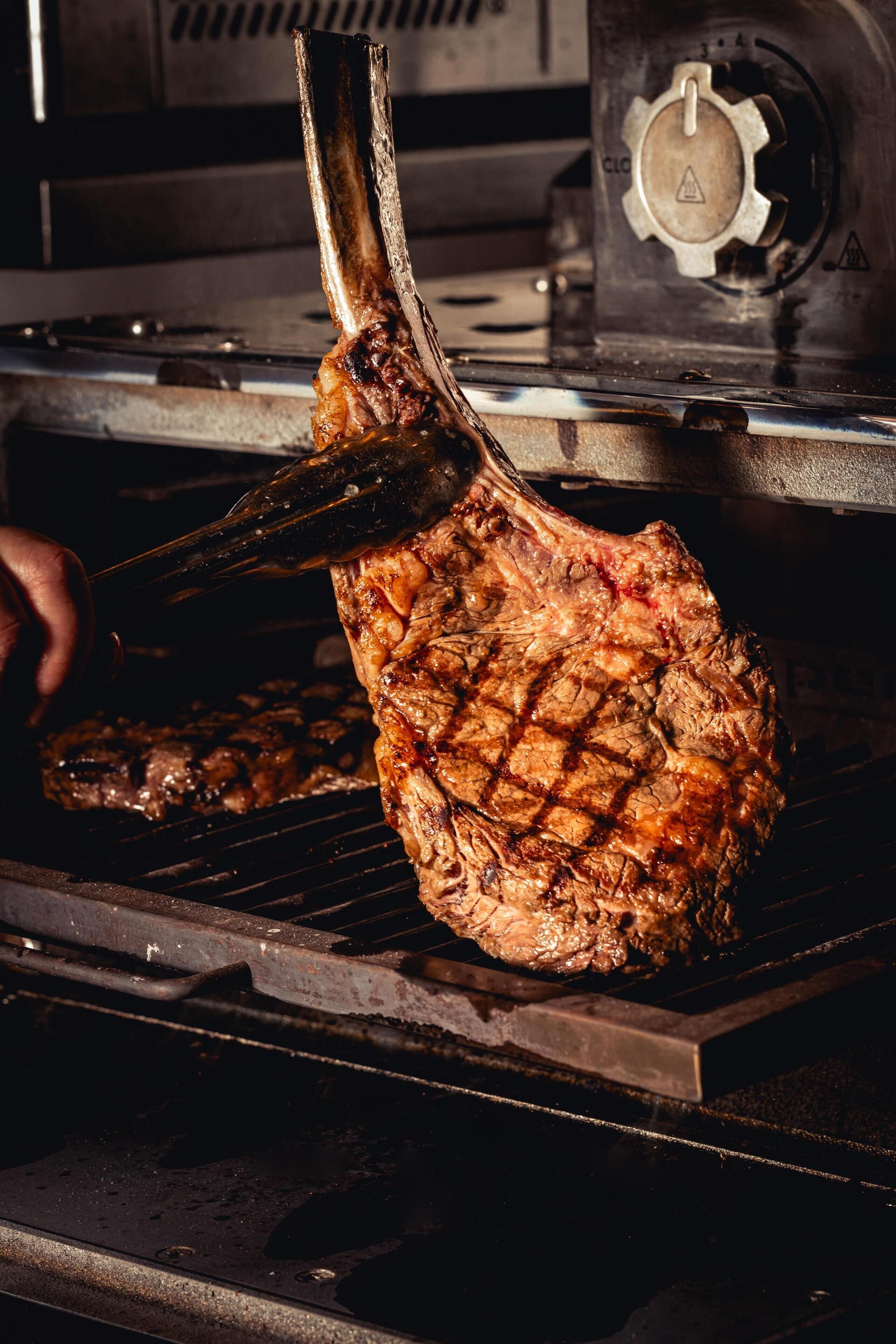 A steak being grilled on a grill.