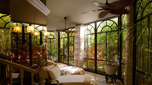 A spa room with a large window, a ceiling fan, and a massage table. - Mount Nelson, A Belmond Hotel, Cape Town (Cape Town)