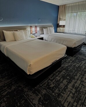 Premium bedding, desk, laptop workspace, blackout drapes