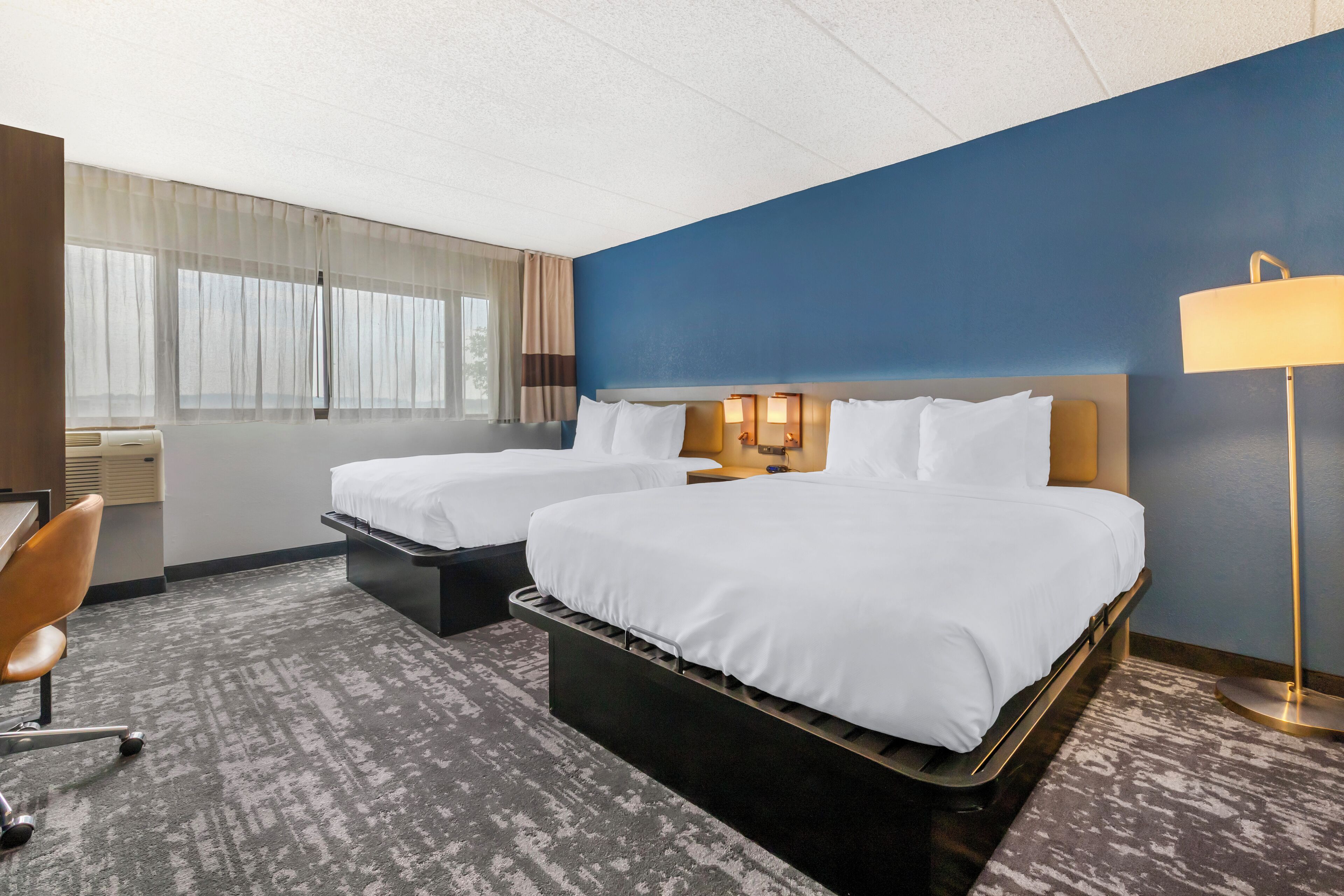 Premium bedding, desk, laptop workspace, blackout drapes