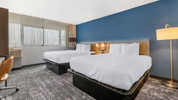 Premium bedding, desk, laptop workspace, blackout drapes