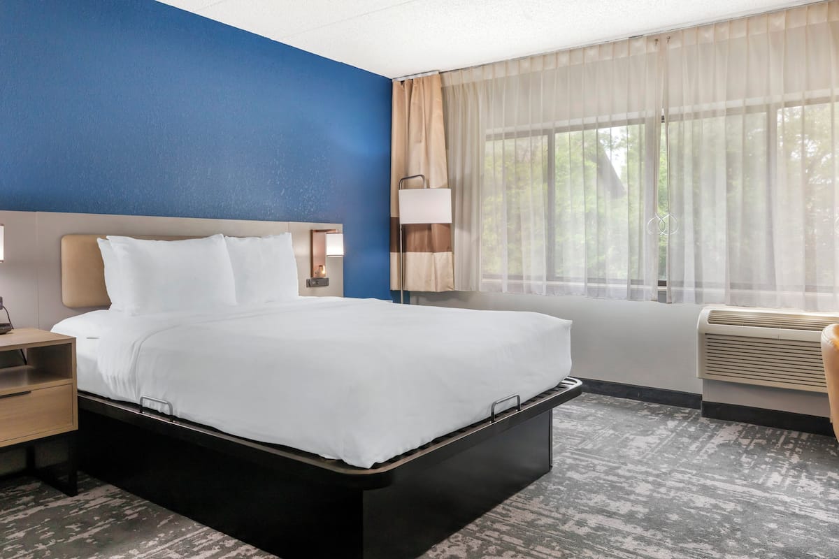 Premium bedding, desk, laptop workspace, blackout drapes