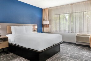 Premium bedding, desk, laptop workspace, blackout drapes