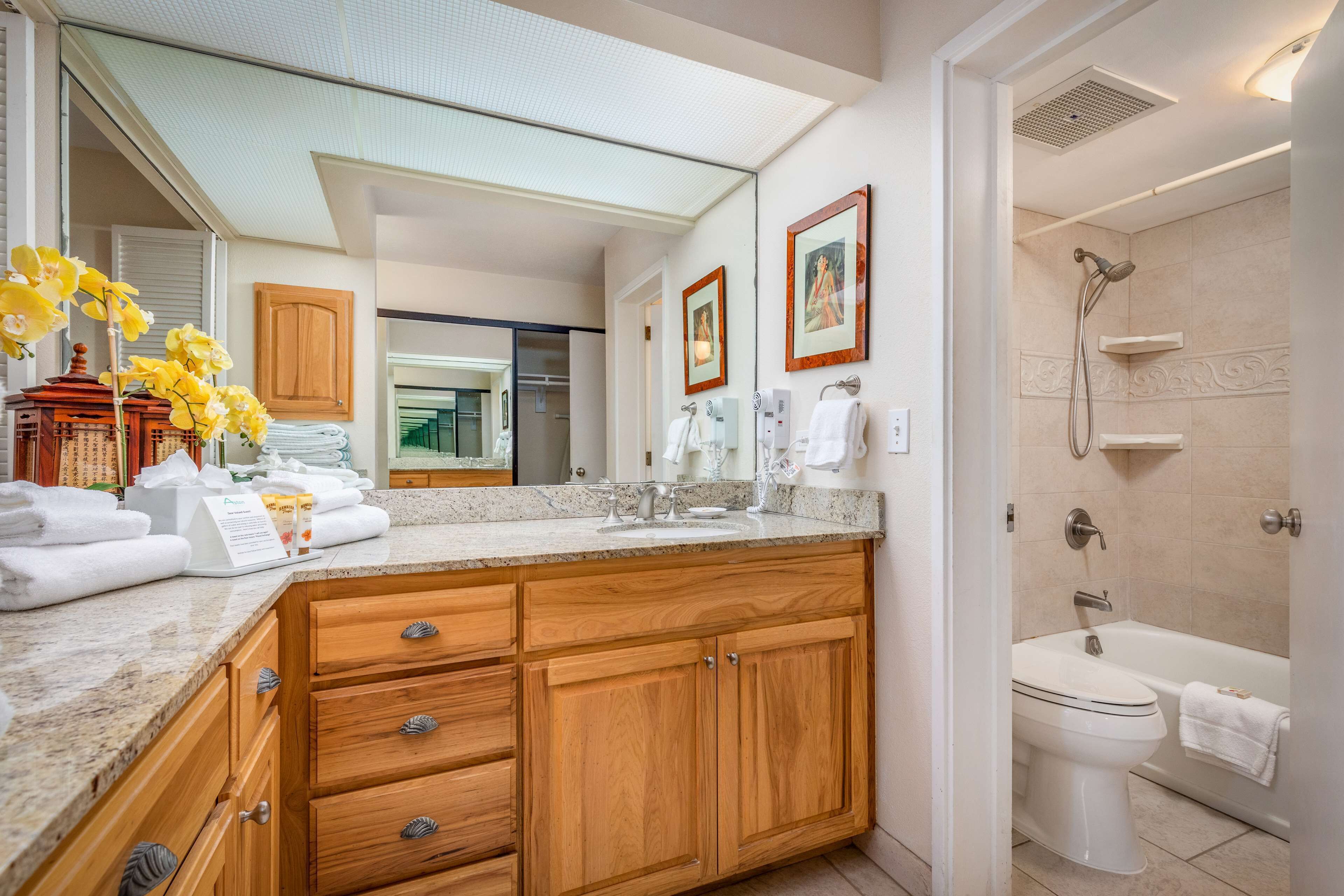 A modern bathroom with a vanity, sink, and shower.