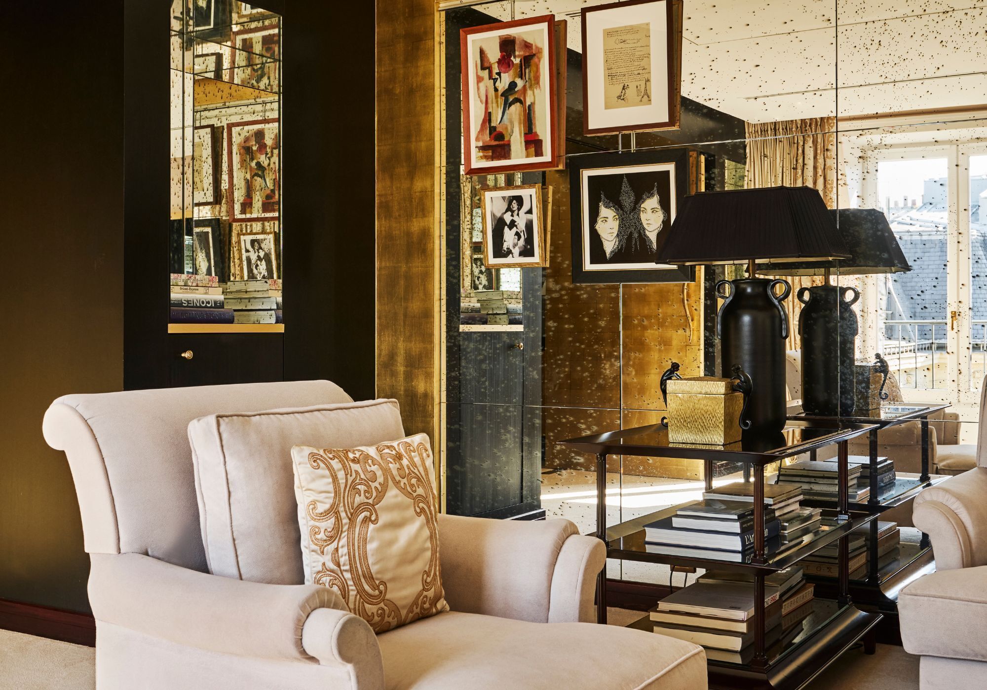 A living room with a sofa, a lamp, and a bookshelf.