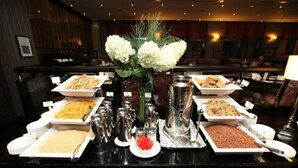 A buffet setup with various food items and condiments. - Ashling Hotel Dublin (Dublin)