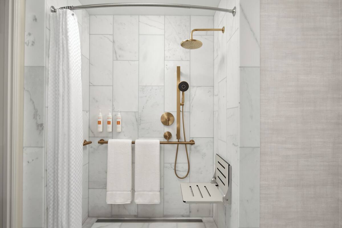 combined shower/bathtub, designer toiletries, hair dryer, slippers