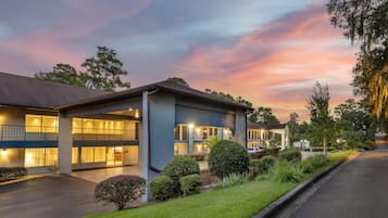 Um hotel com design moderno, com estrutura em dois andares, varandas e janelas amplas.