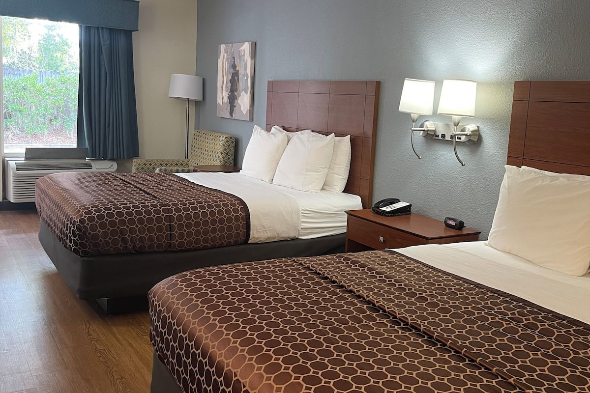 Premium bedding, desk, laptop workspace, blackout drapes