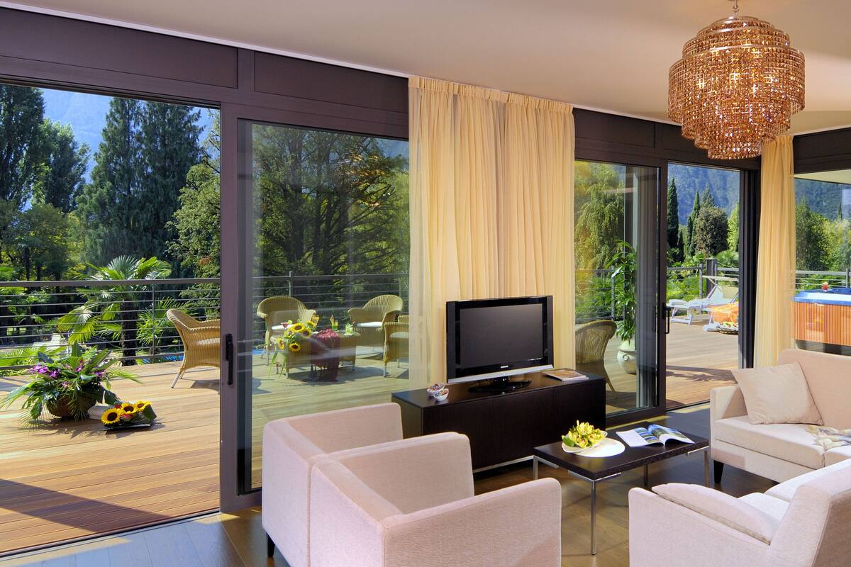 A modern living room with a flat-screen TV, a sofa, and a coffee table.
