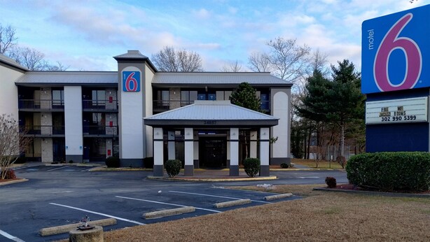 A 6 Motel with a parking lot, a covered entrance, and a signboard advertising free WiFi and Jacuzzi rooms. - Motel 6 Seaford, DE (Seaford)
