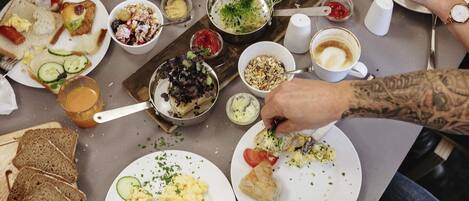 A dining table with various food items and utensils.
