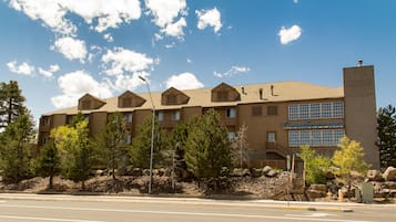 A multi-story building with a sign reading "Comfort Inn." It features a brick facade, multiple windows, and a chimney.