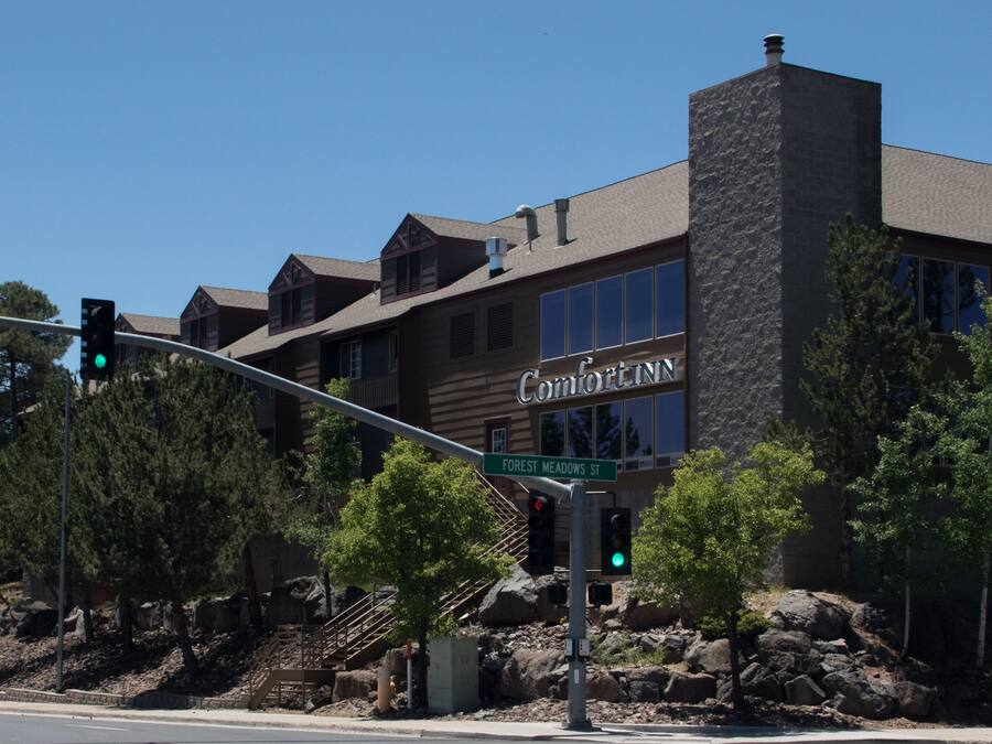 A building with a stone facade and a sign reading "Comfort Inn."